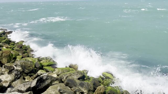 Landscape view of sea waves hitting the coastal rocks