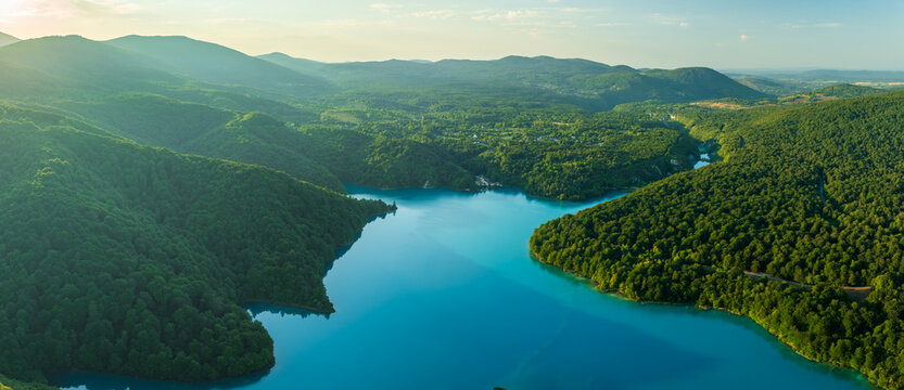 Aerial view of turquoise waters weave through the emerald embrace of forested hills in Plitvice Lakes National Park, Plitvice Lakes National Park, Croatia.