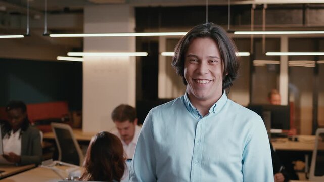 Young male office worker smiling at camera