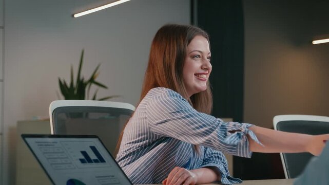 Businesswoman shaking hands with colleague after successful meeting