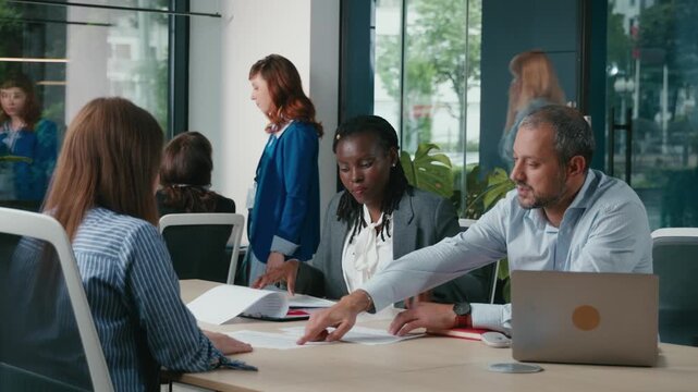 Diverse business team collaborating in a modern office meeting