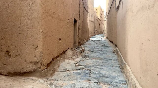 Alleys and pathways of old Omani houses in Al Hamra reflecting traditional mud architecture and heritage.