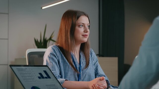 Confident businesswoman discussing project with colleague