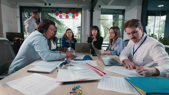 Business team collaborating during meeting in modern office conference room