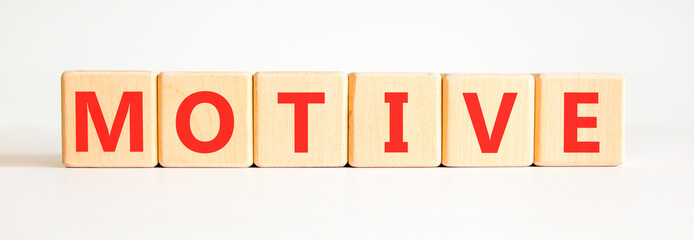 Fototapeta premium Motive support and help symbol. Concept word Motive on beautiful wooden blocks. Beautiful white background. Business psychological motive support and help concept. Copy space.