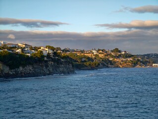 Fototapeta premium Bright seaside retreats, Sunny luxury residences overlooking calm water surrounded by vibrant nature