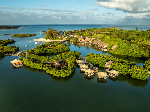 Aerial view of villas nestled amidst lush greenery and tranquil waters, a serene island retreat, Prince Maurice, Flacq District, Mauritius.