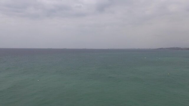 Playa de la Mora Mediterranean sea pine tree pan cloudy overcast wind water