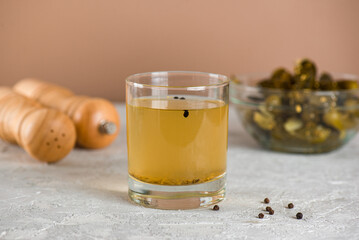 Homemade cucumber juice or brine with cucumbers on the table. Pickled vegetables preserved, canned greens, marinated greens, pickled cucumber.