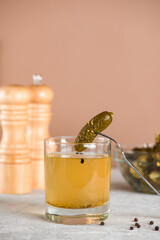 Cucumber pickle drink in a glass with pickled cucumbers. Hangover drink. Vertical orientation.