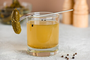 Cucumber juice or brine with cucumbers and pepper on the table. Pickled vegetables preserved, canned greens, marinated greens, pickled cucumber.