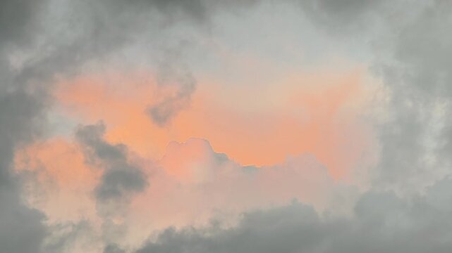 a dramatic cloudscape with a sunset breaking through dark, heavy storm clouds