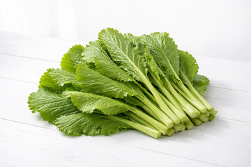 Fresh Green Mustard Leaves on White Minimalist Table