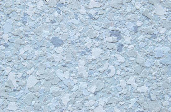 Light blue decorative flakes wall texture or pattern as background