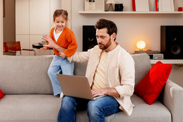 Portrait of bearded man working at home, having video call using laptop