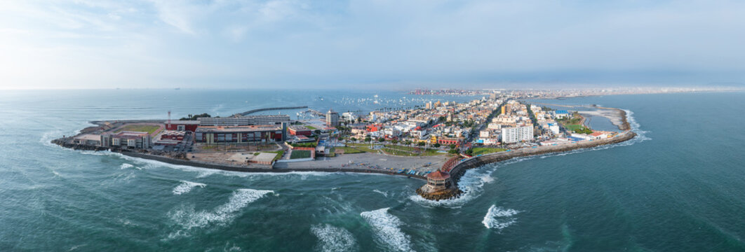 Aerial shot flying from the coast over la punta district towards the city of callao, peru, panorama view