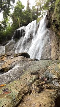 Stunning multi tiered Curug Bibijilan waterfall with emerald green water in Sukabumi, Indonesia.