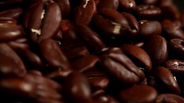 Roasted coffee beans close up with rich brown texture, aromatic caffeine background showcasing freshness, dark roast detail, gourmet coffee concept, barista culture, 