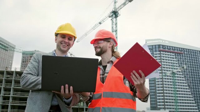 Team of building contractors having conversation during site inspection