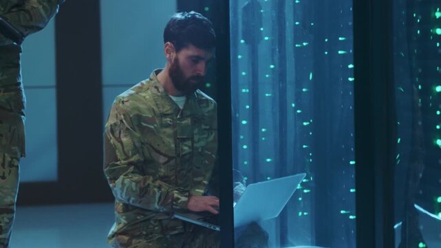 Military technician working, Uniformed personnel operating computer amid lab with glowing machinery and safe environment