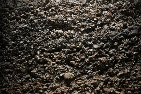 Close-up texture of dark gravel and soil mixture on ground surface