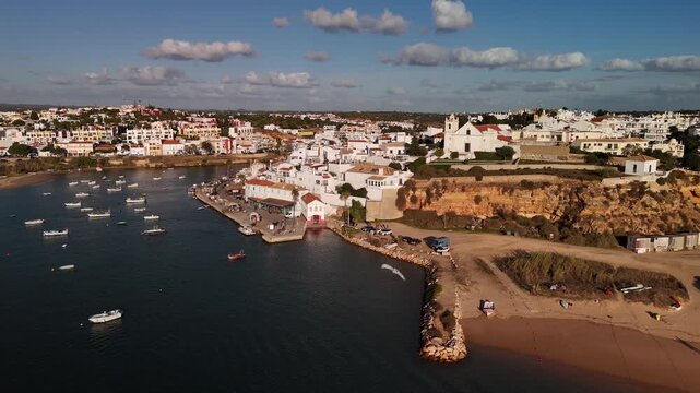 Aerial Cinematic Shot of Ferragudo Traditional Village and Arade River Estuary Algarve Portugal