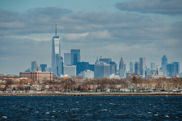 Close up shot of Lower Manhattan skyscrapers and the financial district skyline from across the river during daytime.