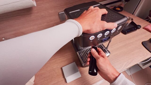 First Person View of Hand Locking Portafilter Into Espresso Machine Showing Firm Grip and Secure Position Before Brewing Process