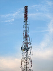 Telecommunication Tower with Antennas Against Blue Sky Background
