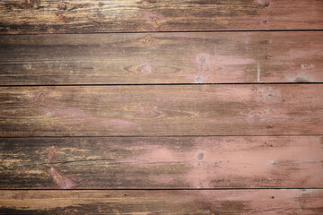 Obraz premium A top-down view of horizontal aged wooden boards with a natural grainy texture, knots, and remnants of old reddish-brown paint. Perfect for rustic backdrops, vintage designs, or food photography surfa