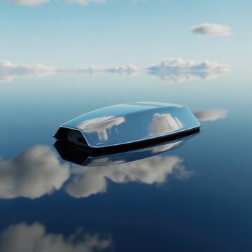 Sleek metallic futuristic vehicle floats on a calm perfectly reflective deep blue water surface under a bright clear sky with white clouds and serene daylight