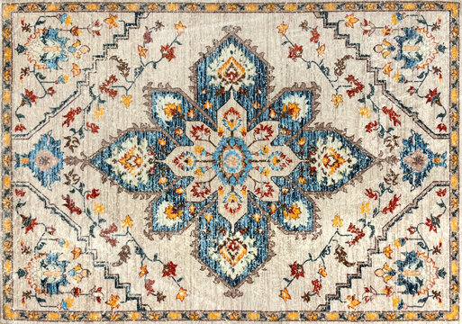 Close up of classic middle eastern Persian rug texture. Engraving and floral ornamental swirls pattern in random blue, beige, red, and white color. For moslem prayer mat and decorative rug. Middle Eas
