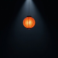 Obraz premium An illuminated traditional orange paper lantern creates a warm glow amidst a stark, dark backdrop, symbolizing a beacon of hope and quiet reflection