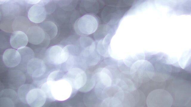 Studio Flashing Light Bokeh Transition, Bright Abstract Light Trails Across White Studio Background. suitable for product ad