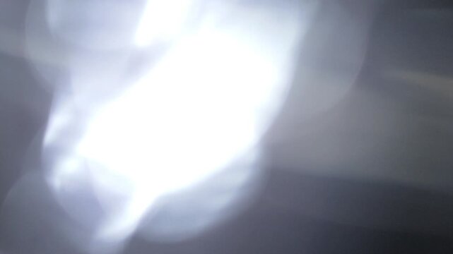 Subtle Flashing Light Bokeh Transition, Abstract Light Blur Across Quiet Dark Frames. ideal for minimal overlay