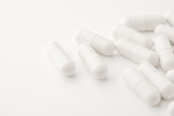 White pills on a white background. Close up
