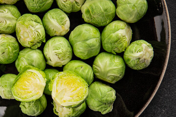 Fototapeta premium Brussels sprouts organic vegetable bio cooking tasty snack fresh gourmet food background on the table rustic food top view copy space vegetarian and vegan food marketing concept photo