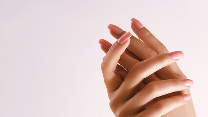 Beautiful Woman Hands. Soft skin, skincare concept. Hand Skin Care. Female Hands Applying Cream or Lotion. Spa and Manicure concept. Female hands with tender pink manicure