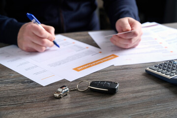 A close-up of car keys and a beautiful keychain on table. © SKfoto GE