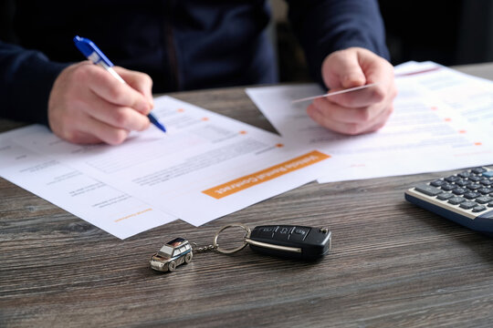 A close-up of car keys and a beautiful keychain on table.