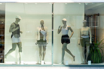 Athletic Clothing Store Window Featuring Mannequins in Modern Fitness Outfits Neutral Colors