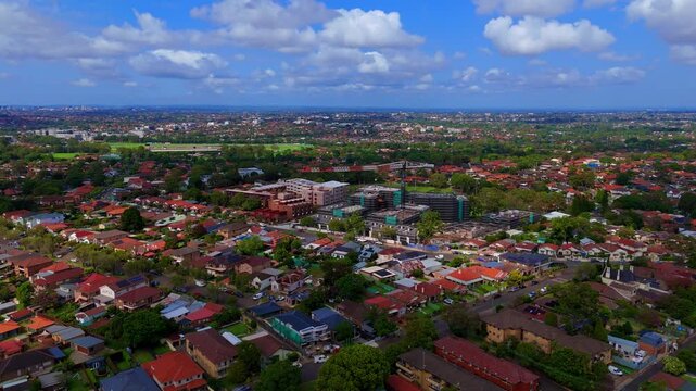 Drone panoramic aerial view of Sydney NSW Australia city Skyline and looking down on roof tops streets roads trees and parks in Suburban Sydney inner west suburbs of Burwood Ashfield Croydon Summer Hi