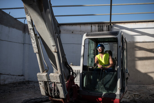 Man working with backhoe in construction site