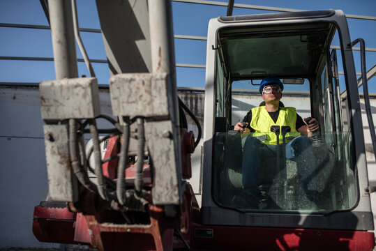 Construction worker operating a backhoe