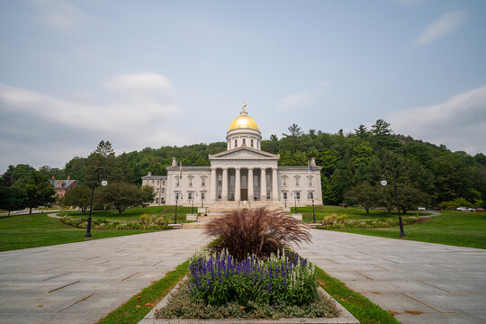 Vermont State House with its iconic gold dome and Greek Revival architecture under a soft sky, Montpelier, USA.