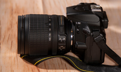 A close-up of a camera on a table. Side view.