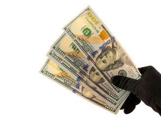 Dollars in a hand in a black glove on a white background