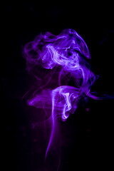 Abstract Purple Smoke against Black Background: Evoking a sense of mystery and artistry, the swirling smoke captivates with its vibrant purple hue set against a deep black backdrop
