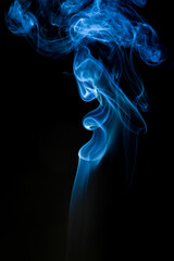 Obraz premium Intriguing swirls of blue smoke on a black backdrop. The smoke creates an abstract and ethereal form, evoking mystery and depth.