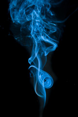 Elegant blue smoke swirling against a black background, with captivating wisps and ethereal shapes. The abstract smoke creates a sense of mystery and artistry.
